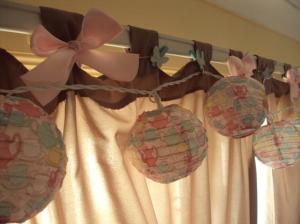 Teacup lanterns, bows on curtain tops and butterfly pegs
